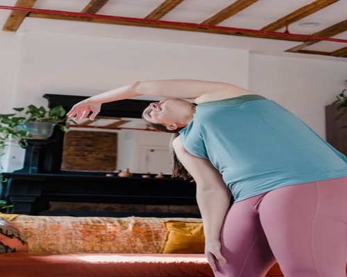 Person doing light stretching in a comfortable living room